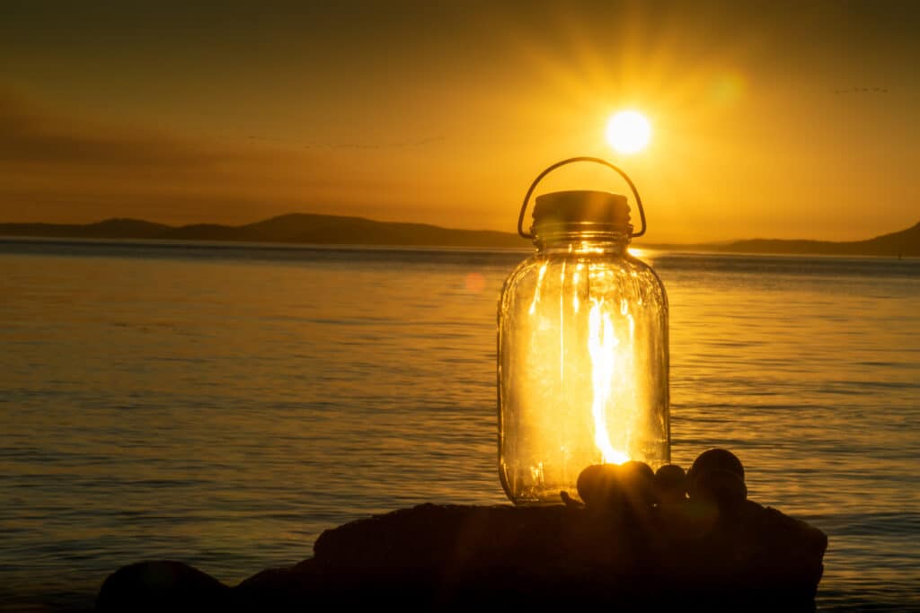 Vintage Glass Bottle lantern lit up from the sunset