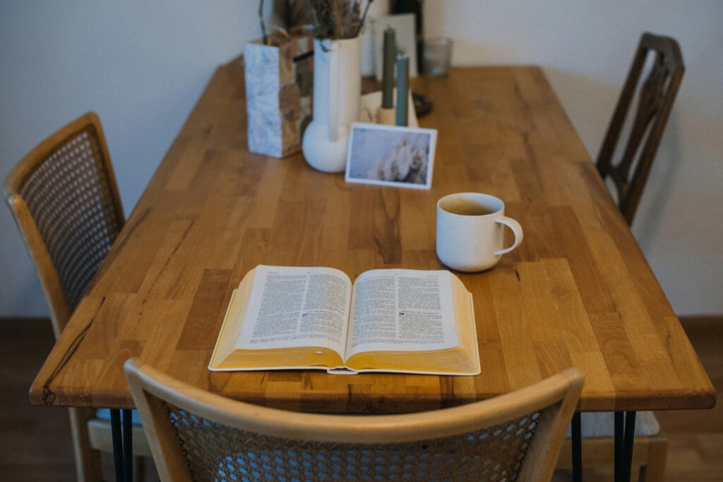 Open Bible and coffee on a table representing reflection and faith-integrated Christian counseling